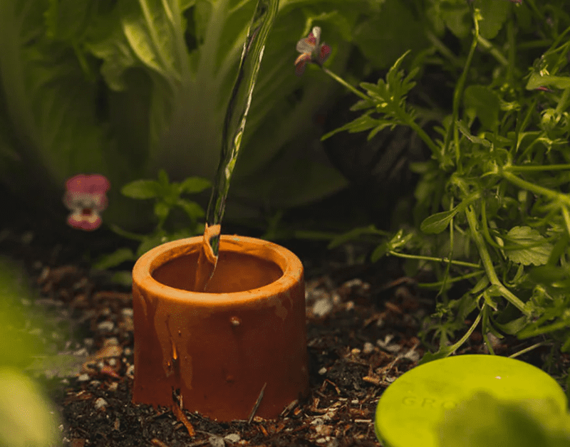 Photo of a GrowOya watering pot underground being used