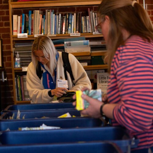 community members picking seeds from bins