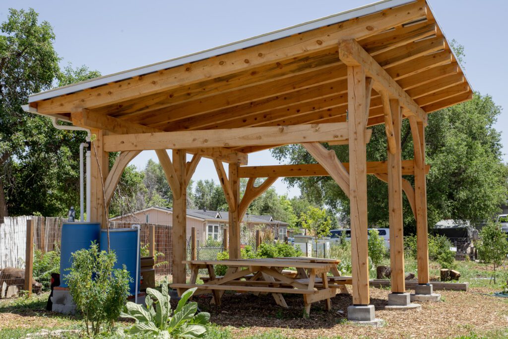 Moody_ElevatedDB_CommGarden__0076 - Denver Urban Gardens wooden pavilion with rain barrel and picnic table