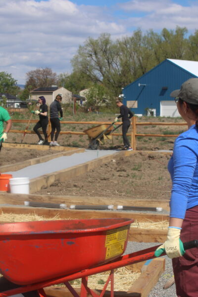 volunteer pushing wheelbarrow tito's 2026