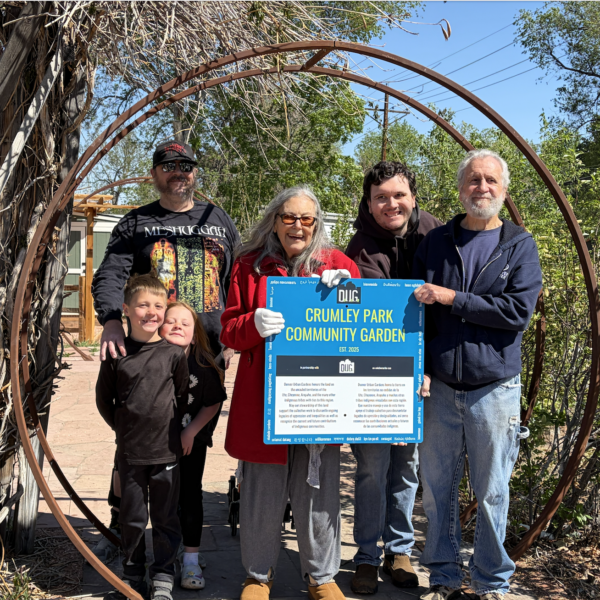 april crumley and family holding garden sign