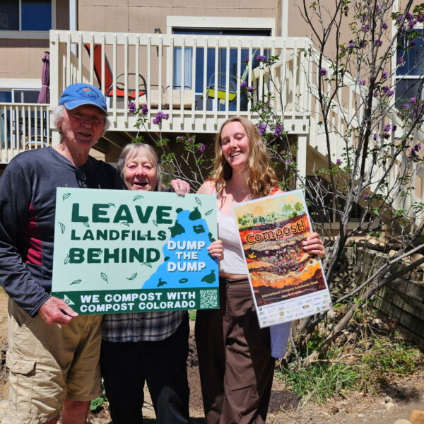 people holding Compost Colorado Signs